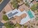 Detailed overhead view of the desert home reveals a refreshing pool, desert landscaping, and solar panels at 4706 E Rancho Caliente Dr, Cave Creek, AZ 85331