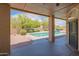 Inviting covered patio area showcasing a beautiful backyard with a sparkling swimming pool and desert landscaping at 4706 E Rancho Caliente Dr, Cave Creek, AZ 85331