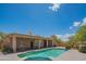 An expansive backyard featuring a pool, covered patio, and desert-friendly landscaping for year-round enjoyment at 4706 E Rancho Caliente Dr, Cave Creek, AZ 85331