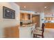 Cozy bar area features seating, cabinets, counter, and views into kitchen and dining area at 4706 E Rancho Caliente Dr, Cave Creek, AZ 85331