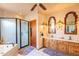 Elegant bathroom featuring a dual sink vanity, soaking tub, and a separate glass-enclosed shower at 4706 E Rancho Caliente Dr, Cave Creek, AZ 85331