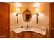 Bathroom with marble countertops, undermount sink and decorative sconces at 4706 E Rancho Caliente Dr, Cave Creek, AZ 85331