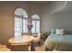 Cozy bedroom featuring arched windows, and a bed with side table at 4706 E Rancho Caliente Dr, Cave Creek, AZ 85331