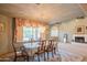 Elegant dining room boasts chandelier, large window with adjacent table and wood furniture, with fireplace view at 4706 E Rancho Caliente Dr, Cave Creek, AZ 85331