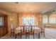 Elegant dining room boasts chandelier, large window with adjacent table and wood furniture at 4706 E Rancho Caliente Dr, Cave Creek, AZ 85331