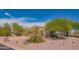 Well-maintained single-story home featuring desert landscaping and a spacious driveway at 4706 E Rancho Caliente Dr, Cave Creek, AZ 85331