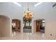 Grand foyer with high ceilings, chandelier, and arched doorways to living and dining rooms at 4706 E Rancho Caliente Dr, Cave Creek, AZ 85331