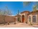 Attractive single-story home showing desert landscaping, including mature trees and a unique entrance at 4706 E Rancho Caliente Dr, Cave Creek, AZ 85331