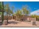 Charming single-story home featuring a desert-landscaped front yard with mature trees and native plants at 4706 E Rancho Caliente Dr, Cave Creek, AZ 85331