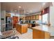 Spacious kitchen with oak cabinets, central island, and stainless-steel refrigerator at 4706 E Rancho Caliente Dr, Cave Creek, AZ 85331