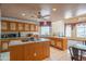 Spacious kitchen features oak cabinets, an island, bright white tile floor, and eat-in dining at 4706 E Rancho Caliente Dr, Cave Creek, AZ 85331