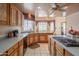 Spacious kitchen with oak cabinetry, light countertops, and eat-in breakfast nook at 4706 E Rancho Caliente Dr, Cave Creek, AZ 85331