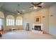 Inviting living room features neutral carpet, fireplace, and bright windows with decorative shutters at 4706 E Rancho Caliente Dr, Cave Creek, AZ 85331