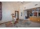 Inviting living room featuring a rocking chair, an open kitchen, and neutral-toned walls at 4706 E Rancho Caliente Dr, Cave Creek, AZ 85331