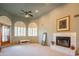 Inviting living room features neutral carpet, fireplace, ceiling fan, and bright windows with decorative shutters at 4706 E Rancho Caliente Dr, Cave Creek, AZ 85331