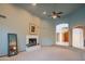 Spacious living area features neutral carpet, fireplace, access to entry way, and adjacent kitchen at 4706 E Rancho Caliente Dr, Cave Creek, AZ 85331