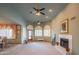 Open floor plan living room with fireplace, bay windows and view into the formal dining room at 4706 E Rancho Caliente Dr, Cave Creek, AZ 85331