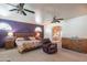 Bright main bedroom featuring ceiling fans, lots of dresser space, and seating area at 4706 E Rancho Caliente Dr, Cave Creek, AZ 85331