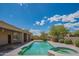 Backyard pool and spa with a large deck and desert landscaping on a sunny day with cloudy skies at 4706 E Rancho Caliente Dr, Cave Creek, AZ 85331