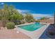 A sparkling pool with a spa invites relaxation and outdoor enjoyment under a bright blue sky at 4706 E Rancho Caliente Dr, Cave Creek, AZ 85331