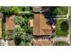Aerial view of a well-maintained home with a brown roof, lovely landscaping, and mature trees at 512 W Roma Ave, Phoenix, AZ 85013