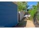 View of fenced backyard with a basketball hoop and gate, offering recreational space and security at 512 W Roma Ave, Phoenix, AZ 85013
