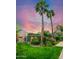 Serene backyard featuring a lush green lawn, mature trees, and a covered patio area for outdoor enjoyment at 512 W Roma Ave, Phoenix, AZ 85013