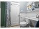 Classic bathroom featuring beadboard walls, mosaic tile flooring, pedestal sink, and a shower at 512 W Roma Ave, Phoenix, AZ 85013