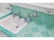 Bathroom sink with a turquoise tiled countertop and a matching turquoise soap dispenser at 512 W Roma Ave, Phoenix, AZ 85013