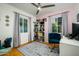 A charming bedroom features a pink accent wall, a blue chair, and a decorative rug on wood floors at 512 W Roma Ave, Phoenix, AZ 85013