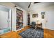 Cozy bedroom with hardwood floors, ceiling fan, large bookshelves, and comfortable seating area at 512 W Roma Ave, Phoenix, AZ 85013