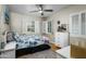 Bright bedroom featuring natural light, hardwood floors, shutters, a ceiling fan, and a dresser at 512 W Roma Ave, Phoenix, AZ 85013