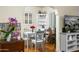 Dining area featuring a white table set, chairs, hardwood floors, and shelving at 512 W Roma Ave, Phoenix, AZ 85013