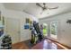 Bright exercise room with exercise equipment, ceiling fan, access door to outside, and colorful artwork at 512 W Roma Ave, Phoenix, AZ 85013