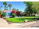 Charming home with vibrant bougainvillea, manicured lawn, and mature trees creating a picturesque setting at 512 W Roma Ave, Phoenix, AZ 85013