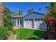 Spacious detached garage with double doors and a side entry, surrounded by lush landscaping at 512 W Roma Ave, Phoenix, AZ 85013