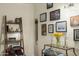 Hallway featuring decorative console table with tulips, ladder shelf, and an array of framed art at 512 W Roma Ave, Phoenix, AZ 85013