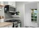 Cozy kitchen featuring modern appliances, including a stainless steel oven and microwave at 512 W Roma Ave, Phoenix, AZ 85013