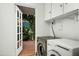 Laundry room with modern washer and dryer, white cabinets, and outdoor view at 512 W Roma Ave, Phoenix, AZ 85013