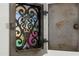 Close-up of a charming vintage mail slot with intricate metalwork and a glimpse of colorful glass at 512 W Roma Ave, Phoenix, AZ 85013