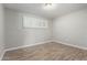 Cozy bedroom showcasing wood-look floors, a window with blinds, and fresh paint at 523 W 14Th St, Tempe, AZ 85281