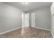 Bedroom features wood-look floors and a closet and adjacent access to another room at 523 W 14Th St, Tempe, AZ 85281