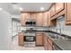 Well-equipped kitchen boasting stainless steel appliances, wood cabinets, and modern countertops at 523 W 14Th St, Tempe, AZ 85281
