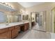 A bright bathroom with double sinks, a large mirror, and a glass-enclosed shower at 5330 W Morgan Pl, Chandler, AZ 85226