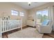 Cozy Bedroom featuring a crib, dresser, and a comfortable armchair for nursing at 5330 W Morgan Pl, Chandler, AZ 85226