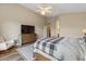 A spacious bedroom with a ceiling fan, dresser, and a comfortable chair for relaxing at 5330 W Morgan Pl, Chandler, AZ 85226