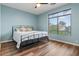 This bedroom features wood floors and a large window at 5330 W Morgan Pl, Chandler, AZ 85226