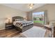 Cozy bedroom with wooden floors, large windows, and a rocking chair at 5330 W Morgan Pl, Chandler, AZ 85226