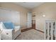 Warm Bedroom with a crib, chair, and a soft rug at 5330 W Morgan Pl, Chandler, AZ 85226