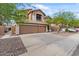 Home showcasing a well-maintained yard, a three-car garage, and a side gate entrance at 5330 W Morgan Pl, Chandler, AZ 85226